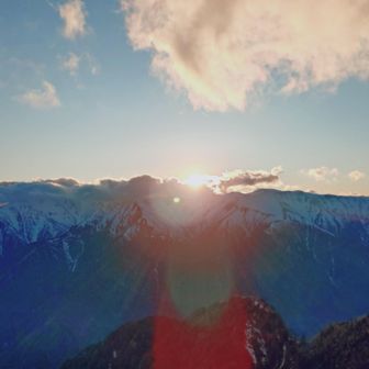 北アルプスの峰に沈む夕日を撮影
