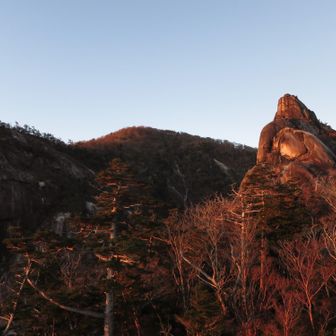 朝日を浴びる大崩山頂と下ワク塚。