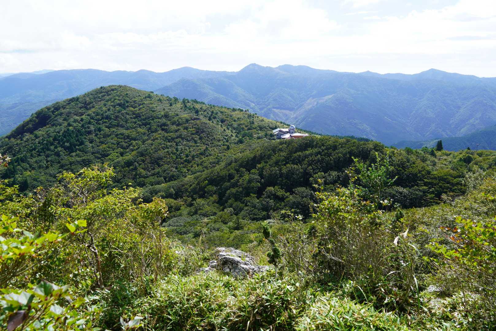 樹林帯を抜けると山荘と二人の丘方面の展望