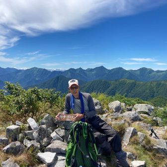 日髙山脈の中心部をバックに。今日も誰にも会わないと思っていたら下山開始前に高速若者1人到着。その人に撮っていただきました。