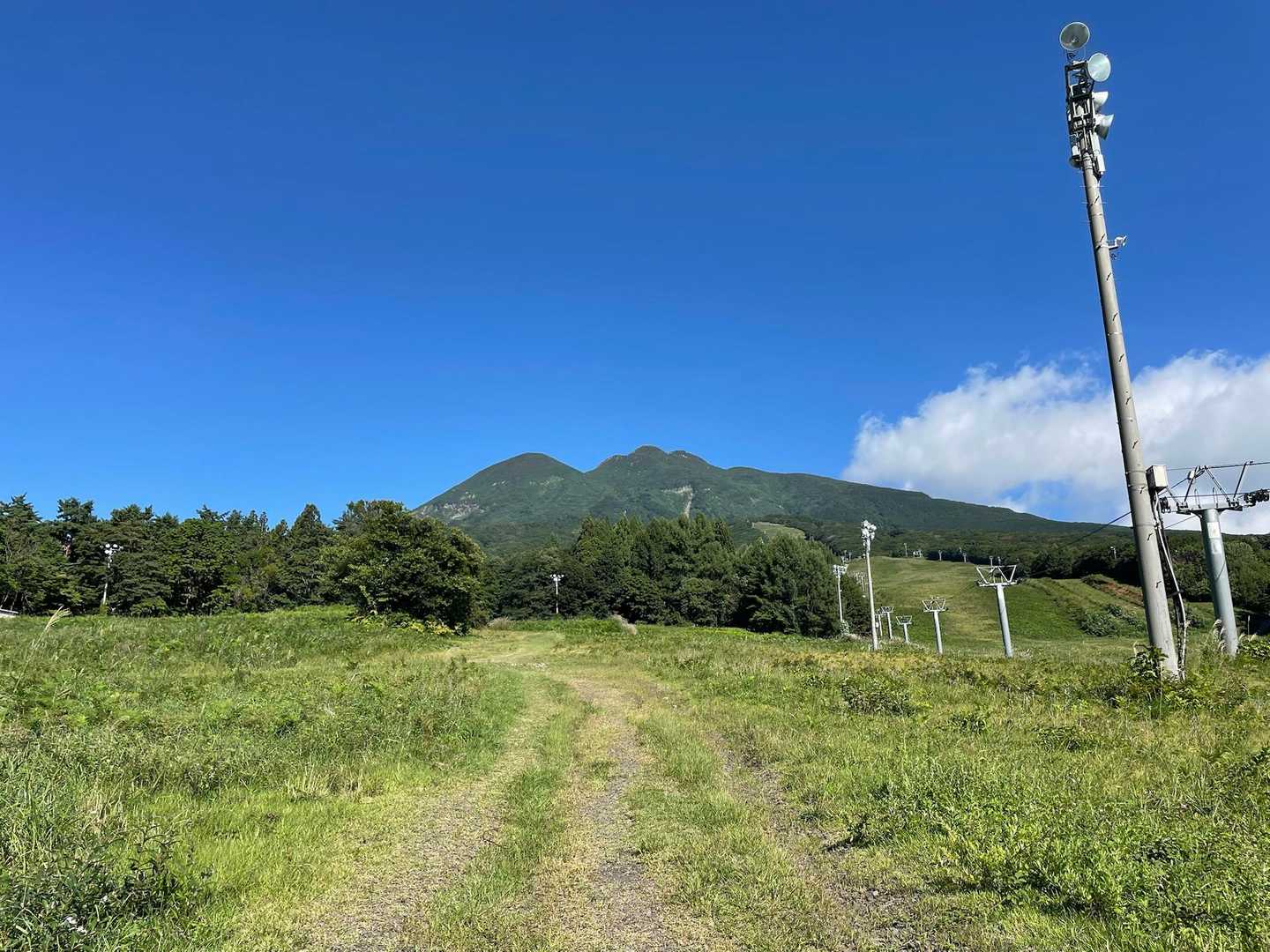 最初は平坦な道を歩きます。青い空に、独特な山容が映えます。暑くなりそう。