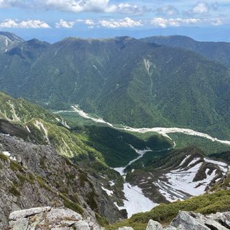 東を見ると、左端に安曇野のシンボル常念岳、真ん中には平らな山頂の蝶ヶ岳です🦋　真下には左手の横尾から右手の徳沢にかけての梓川、そして右下の雪渓の方をzoomしてよ〜く見ると、、、👀