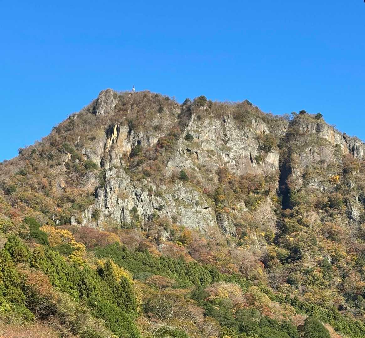 険しい山頂に白いパラボラアンテナが見えます。左の尾根から登るのでしょう。まさかあの岩壁ではないですよね。