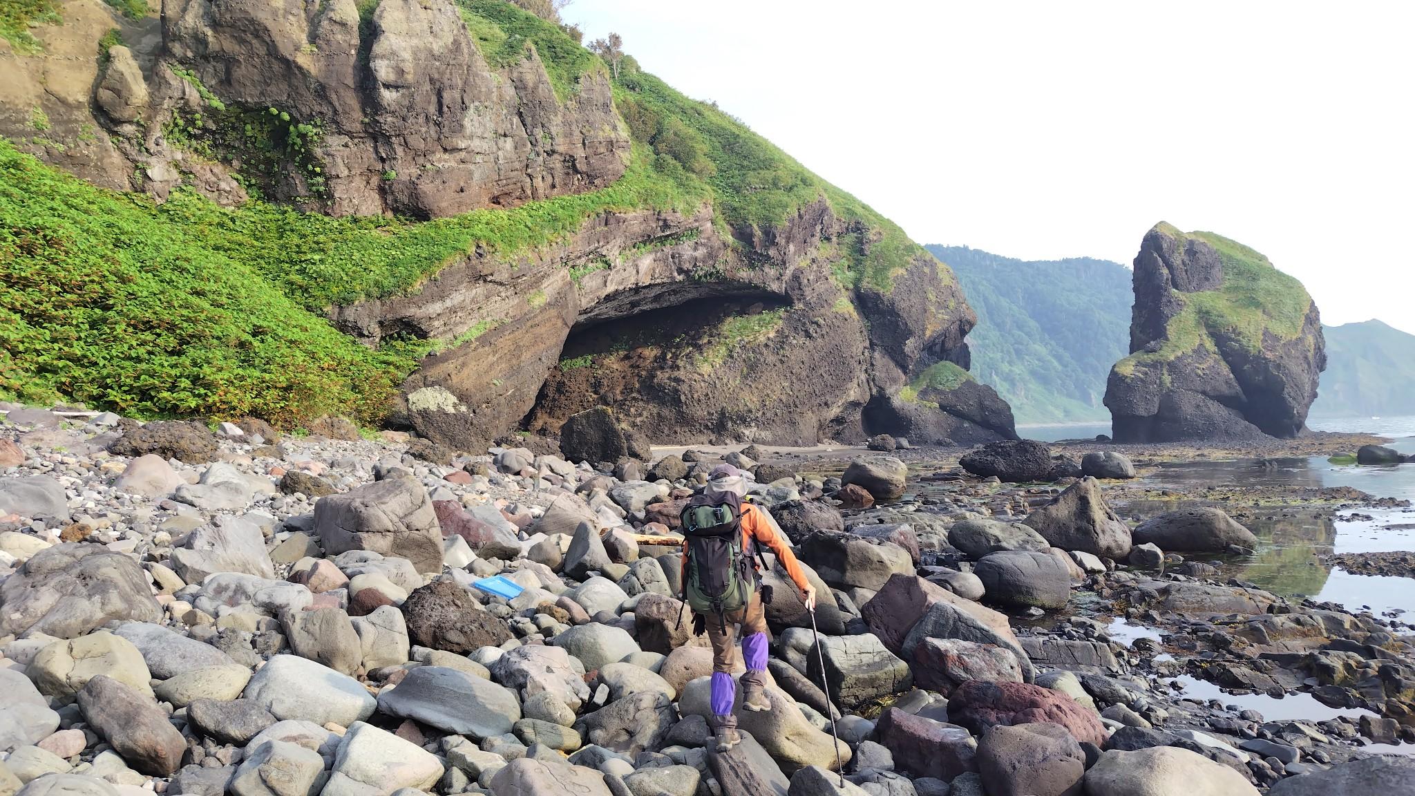 スタートしてすぐに難所の念仏岩。画面正面の洞穴上部の斜面を右上に進む。
その先の森の中を残置ロープを利用しながら登っていく。
念仏岩の下りは残置ロープがあるものの、8mほどほ垂直のガケ。足場も判然としないのでココは下降器を利用（じつは、これが人生初の懸垂下降）。